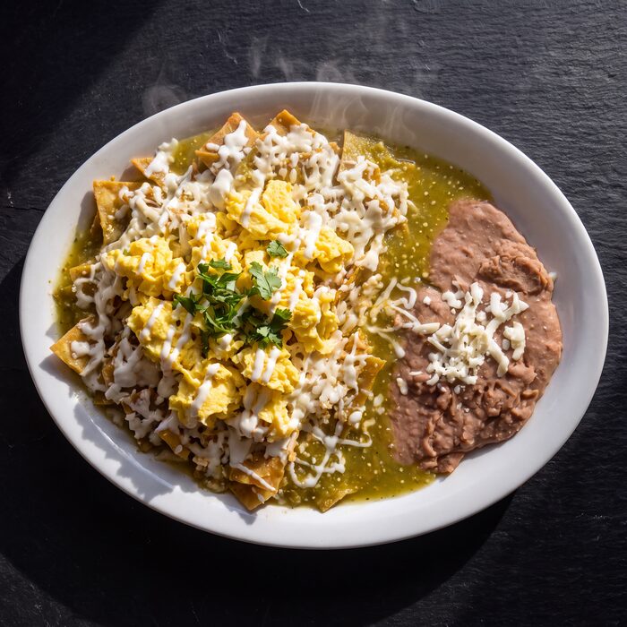 Chilaquiles Verdes, seen from above on a white plate.