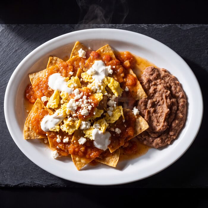 Chilaquiles Rancheros, seen from above on a white plate.