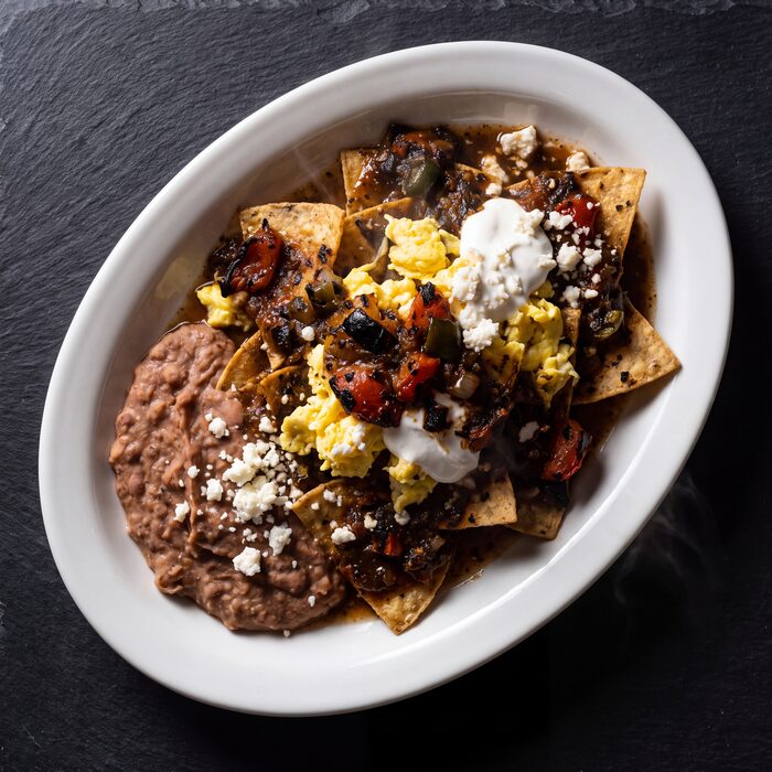 Chilaquiles Chile Asado, seen from above on a white plate.