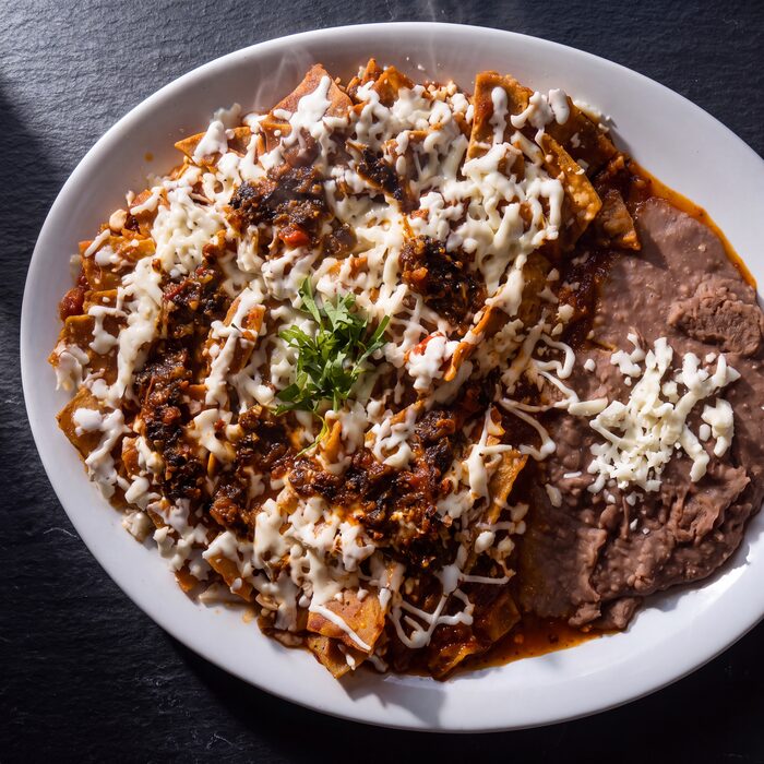 Chilaquiles Salsa de Molcajete, seen from above on a white plate.