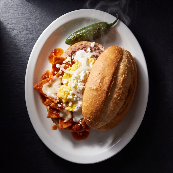 Torta de chilaquiles, seen from above on a white plate.