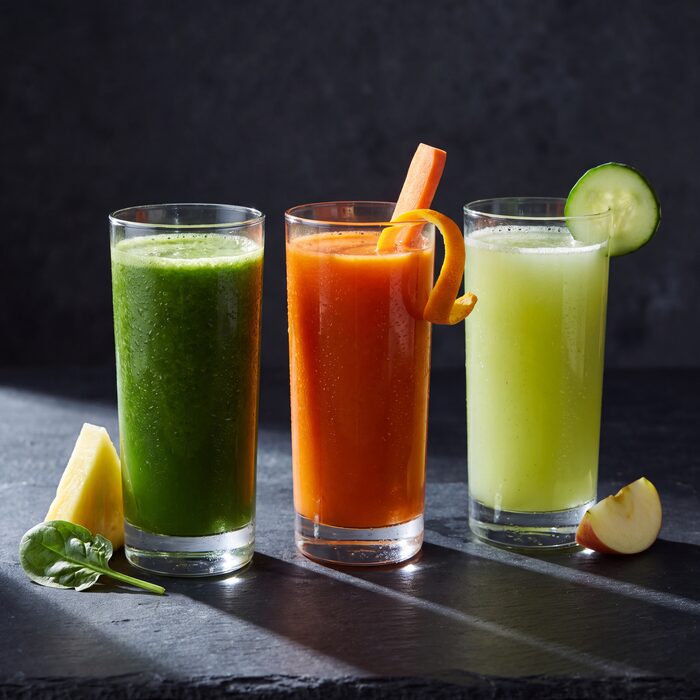 Three tall glasses of fresh juice, seen from above.